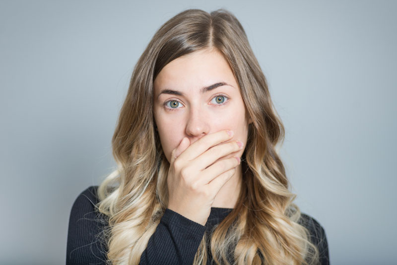 Dental Patient Covering Her Mouth