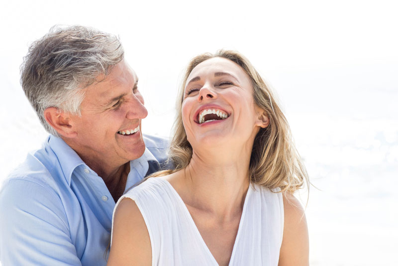 Two Dental Patients Smiling After Their Dental Implant Procedures