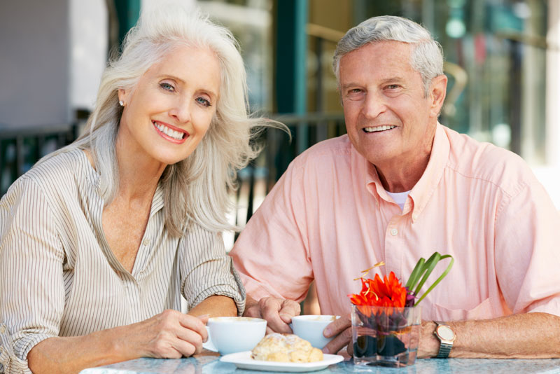 Dental implant patients smiling during brunch