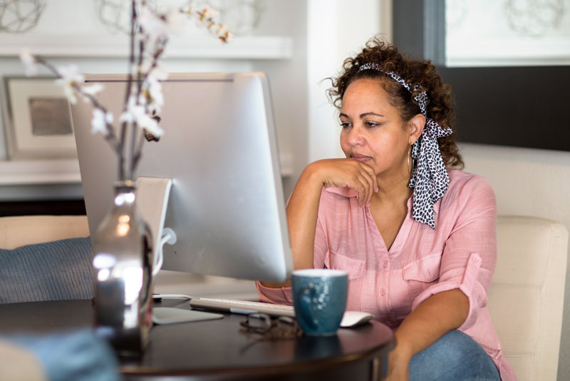 dental implant patient researching implant options on a computer